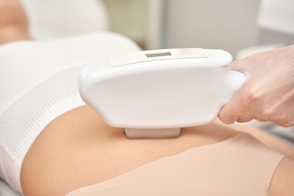 Female getting non-invasive body sculpting treatment